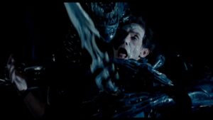 A still from Aliens showing Bishop being stabbed through his torso with the Alien queen's spearlike tail.
