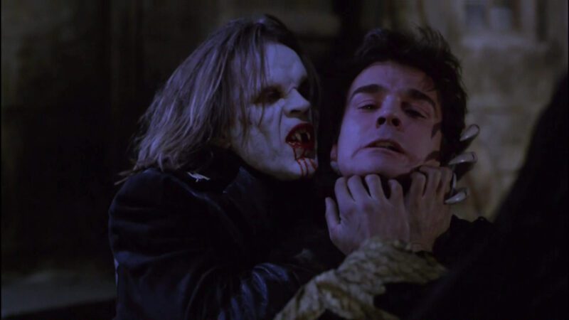 Vampire brothers, Radu and Stefan from the movie Subspecies; Radu holds Stefan by the throat menacingly.